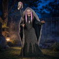 Hallowmere Witch Animatronic lit pink in a misty yard, staff skull glowing above her